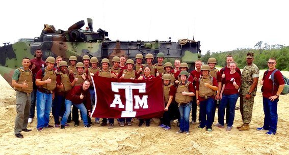 Lt. Col. Carlos T. Jackson, right, and retired Lt. Col. Chris Emmerson, far left, pose with students from the Texas A&M Corps of Cadets in front of an Amphibious Assault Vehicle assigned to Combat Assault Battalion, 3rd Marine Division, May 18, 2016, at Camp Schwab, Okinawa, Japan. The Cadets visited Okinawa as part of a scholarship program which provides students the opportunity to tour military installations to learn about different occupational specialties and duty stations. This is the first time Texas A&M Corps of Cadets visited Okinawa.