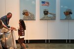 Artist Steve Alpert thanks a Brownie Scout for helping him unveil the triptych “Portrait of a Woman” at the Women in Military Service for America Memorial located at the entrance of Arlington National Cemetery, Va., June 13, 2016. DoD photo by Jim Garamone