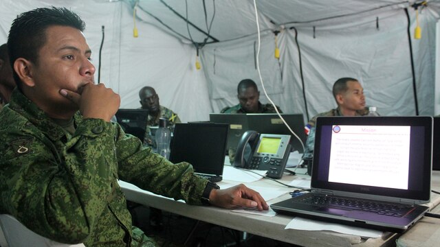 Capt. Edwin Oliva, executive officer of Operations, Belize Defense Force, listens to a brief on Command and Control during Phase II of exercise Tradewinds 2016, at Up Park Camp, Jamaica, June 24, 2016. Tradewinds 2016 is a Chairman of the Joint Chiefs of Staff-approved, U.S. Southern Command-sponsored combined joint exercise conducted in conjunction with 17 partner nations to enhance the collective ability of their defense forces and constabularies to counter transnational organized crime and conduct humanitarian/disaster relief operations, while developing strong relationships and reinforcing human rights awareness.