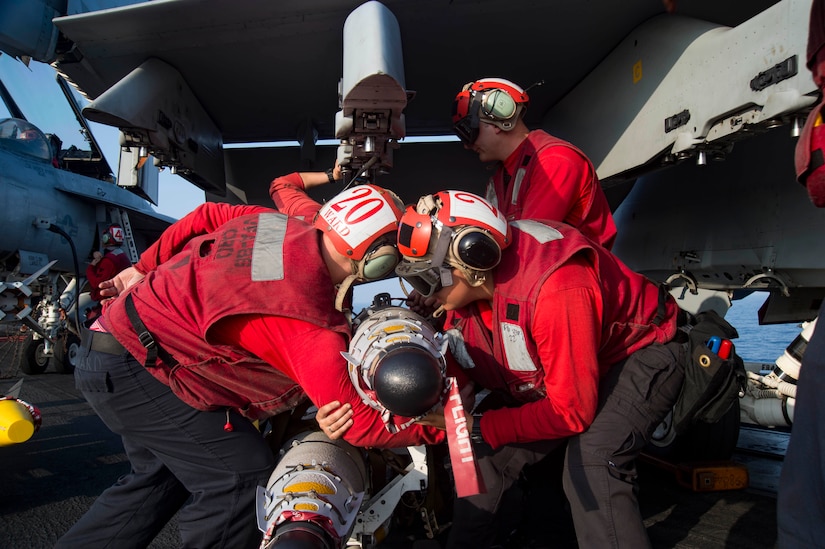 Sailors prepare to load ordnance onto a Navy F/A-18E Super Hornet assigned to Strike Fighter Squadron 86 on the flight deck of the aircraft carrier USS Dwight D. Eisenhower, deployed in the Mediterranean Sea, June 28, 2016. The USS Eisenhower is deployed in support of Operation Inherent Resolve, the U.S.-led coalition to degrade and defeat the Islamic State of Iraq and the Levant. Navy photo by Petty Officer 3rd Class Anderson W. Branch