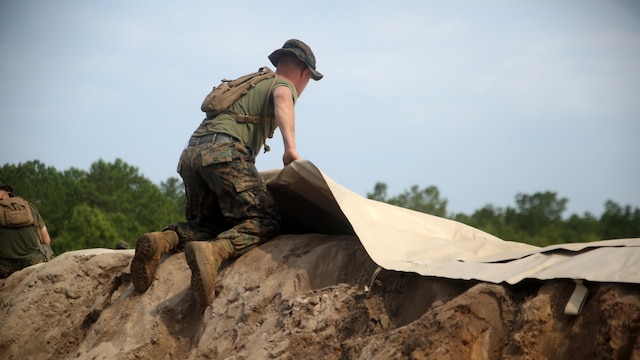 A Marine with Bulk Fuel Company, 8th Engineer Support Battalion, assists in setting up an amphibious assault fuel system at Marine Corps Base Camp Lejeune, North Carolina, June 24, 2016.
