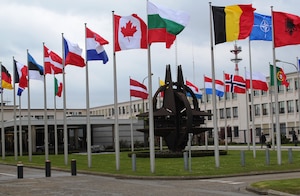 The flags of the 28 NATO member countries flap in the wind in front of headquarters in Brussels. 