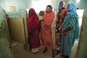 men in line at polling center in Nyala, South Darfur, on the first day of voting in South Sudan’s referendum on independence in January 2011.