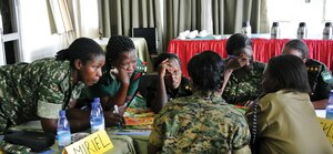 Women from the Uganda People’s Defense Force (UPDF) work on a village mapping exercise in Kampala during Dallaire Initiative's Women and Security Sector training. The village mapping exercise teaches training participants areas where children may be susceptible for recruitment by armed groups and how to prevent this.