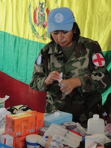 Bolivian peacekeeper providing medical and dental support for internally displaced persons in Cité Soleil, Haiti.