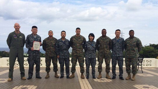 Members of the Japanese Air Self Defense Force pose with U.S. Marines for a photo at a farewell luncheon for the professional military exchange program February 23 at the Habu Pit Officers’ Club on Marine Corps Air Station Futenma. The professional military exchange program benefits JASDF and Marines by providing first-hand insight to the daily routines and responsibilities of each service, according to Staff Sgt. Shinya Nishida, second from left. The experience and knowledge gained through the program establishes better understanding and communication. After Nishida’s exposure to the Marine Corps, the JASDF will return the favor by taking in a Marine in March to experience day-to-day routines of the JASDF. Nishida was a participant of the program and is a flight plan dispatcher with the JASDF.