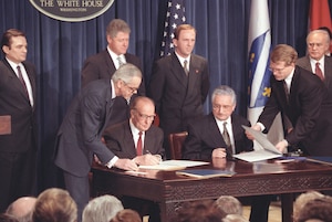 Male political leaders sign the Croat-Muslim Federation agreement at The White House in March 1994