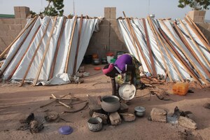 A woman displaced by Boko Haram prepares a meal at an IDP camp in Yola, Adamawa.