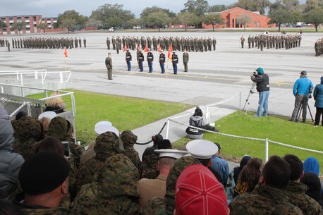 Honor Graduate stand ready to be relieved of their guide ons as educators watch from the stands March 4, 2016, aboard Marine Corps Recruit Depot Parris Island, S.C. The educators participated in a three-day workshop that afforded them the opportunity to experience a little of Marine Corps bootcamp. The workshop is to educate and inform educators about military service and life in the Marine Corps. (Official Marine Corps photo by Cpl. Diamond N. Peden/Released)