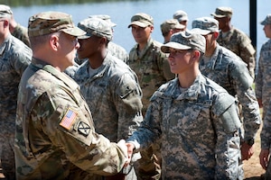Army Chief of Staff Mark A. Milley shakes hands with Capt. Kristen M. Griest, one of the latest Soldiers to earn the Ranger tab (Aug. 21, 2015).