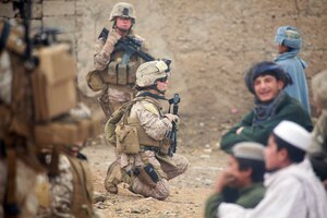 101029-M-5881H-124 U.S. Marine Corps Lance Cpl. Sienna De Santis and U.S. Navy Petty Officer 3rd Class Heidi Dean, both with Female Engagement Team, India Company, 3rd Battalion, 5th Marine Regiment, Regimental Combat Team 2, greet children during a patrol in Sangin Valley, Afghanistan, on Oct. 29, 2010. Marines conducted security patrols to decrease insurgent activity and gain the trust of the Afghan civilians. The battalion was one of the combat elements of Regimental Combat Team 2, whose mission was to conduct counterinsurgency operations with the International Security Assistance Force. DoD photo by Cpl. David Hernandez, U.S. Marine Corps. (Released)