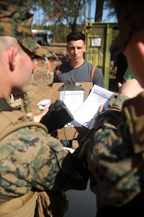 Marines with Combat Logistics Battalion 2, verify the identity of a notionally-displaced citizen at the first station of the Evacuation Control Center during the battalion’s certification exercise, at Marine Corps Auxiliary Landing Field Bogue, N.C., March 10, 2016. The battalion is slated to deploy on Special Purpose Marine Air-Ground Task Force-Crisis Response-Africa later this year. (U.S. Marine Corps photo by Cpl. Joey Mendez)