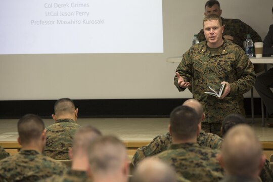 Maj. Daniel White, staff judge advocate at Marine Corps Air Station Iwakuni, Japan, introduces the guest speakers during the Legislation for Peace and Security seminar at MCAS Iwakuni March 11, 2016. Recent changes in national policy gives Japan the capability to take a more proactive stance in matters that may threaten Japan, its citizens and its allies. (U.S. Marine Corps photo by Cpl. Nathan Wicks/Released)