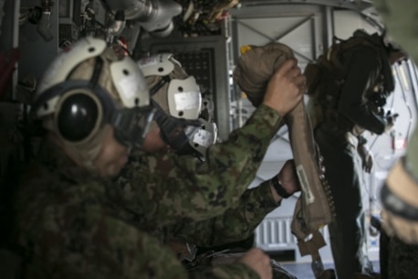 Japan Ground Self-Defense Force service members prepare for a flight on an MV-22B Osprey by putting on cranials to protect their head and ears, as well as an inflatable vest in case of emergency over a body of water, during their visit to Marine Corps Air Station Futenma, Okinawa, Japan, March 8, 2016. U.S. Marine crew chiefs give safety briefs to their passengers before each flight, explaining emergency exits, evacuation steps. The Japanese service members visited MCAS Futenma to strengthen relations in the Asia-Pacific and to view the capabilities of the Osprey firsthand. The Osprey is with Marine Medium Tiltrotor Squadron 262, Marine Aircraft Group 36, 1st Marine Aircraft Wing, III Marine Expeditionary Force. (U.S. Marine Corps photo by Cpl. William Hester/ Released)
