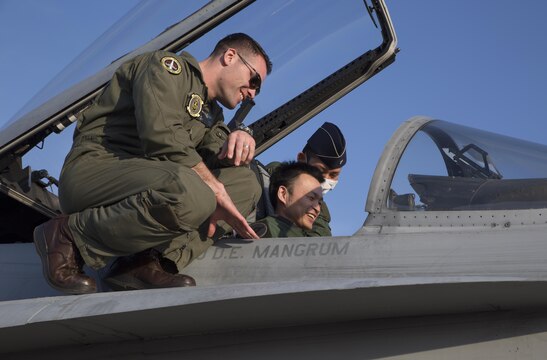 Capt. Robert Ahern, a F/A-18 pilot with Marine Fighter Attack Squadron (VMFA) 314, shows an F/A- 18AA++ aircraft to Japan Air Self-Defense Force members during the Komatsu Aviation Training Relocation exercise at Komatsu Air Base, Japan, March 17, 2016. VMFA-314, home based out of Marine Corps Air Station Miramar, San Diego, temporarily deployed to MCAS Iwakuni for a six month rotation with the unit deployment program, is forward deployed to Komatsu, Japan for the ATR.  Komatsu ATR is a dissimilar air combat training exercise allowing pilots with diverse aircraft to simulate aerial warfare and execute basic fighter maneuvers, aircraft tactical intercepts and offensive-defensive counter air missions in preparation for real wartime situations. (U.S. Marine Corps photo by Cpl. Nicole Zurbrugg/Released)