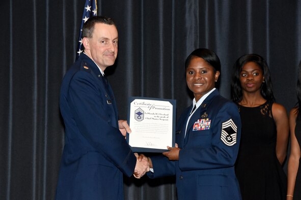 Chief Master Sgt. Lashanda Cleveland receives her promotion certificate during her promotion ceremony at the U.S. Air Force Expeditionary Center on Joint Base McGuire-Dix-Lakehurst on Feb. 29, 2016. (U.S. Air Force photo/Danielle Brooks)