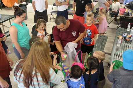 Sergeant Jason Gonzalez, supply clerk for Recruiting Station Orlando, passes out Easter eggs to children during RS Orlando’s Easter Family Day March 19, 2016, Lakeland, FL. Gonzalez said he was happy that he could assist in bringing the children joy.  