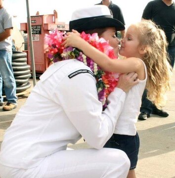 Chief Petty Officer Jaclyn Place kisses her daughter. Place is a lead chief petty officer with the Headquarters Regimental Aid Station, 1st Marine Logistics Group, and was awarded an impact Navy and Marine Corps Commendation Medal for her selfless and decisive actions that saved the lives of her neighbors. (U.S. Marine Corps photo by Sgt. Laura Gauna/released)