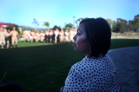 Jennifer Barela, one of Chief Petty Officer Jaclyn Place’s neighbors and the survivors of the brutal attack, looks out at dozens of Marines during Place’s award ceremony aboard Camp Pendleton, Calif., March 11, 2016. Place, a lead chief petty officer with the Headquarters Regimental Aid Station, 1st Marine Logistics Group, was awarded an impact Navy and Marine Corps Commendation Medal for her selfless and decisive actions that saved the lives of Barela and her daughter. (U.S. Marine Corps photo by Sgt. Laura Gauna/released)