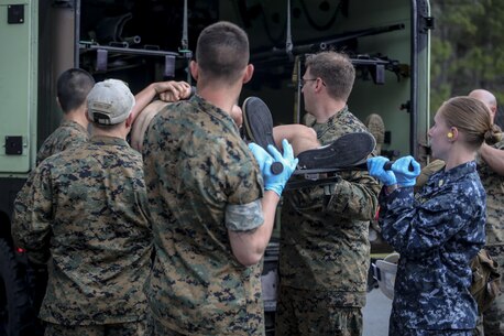 Sailors with 2nd Medical Battalion load a simulated casualty into a medical humvee during a mass casualty training scenario at Camp Lejeune, N.C., March 25, 2016. The injuries the sailors encountered included notional gunshot wounds, blast wounds and burns. (U.S. Marine Corps photo by Cpl. Paul S. Martinez/Released)