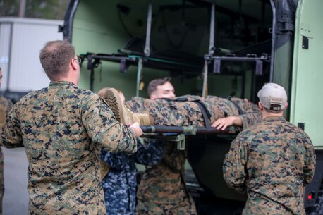 Sailors with 2nd Medical Battalion load a simulated casualty into a medical humvee during a mass casualty training scenario at Camp Lejeune, N.C., March 25, 2016. The training was held to evaluate medical personnel capabilities in a field environment with limited manpower and resources. (U.S. Marine Corps photo by Cpl. Paul S. Martinez/Released)