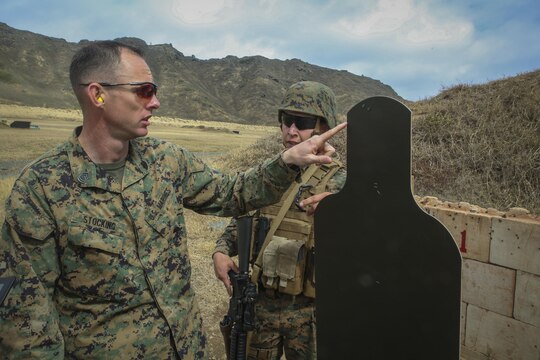 MARINE CORPS BASE HAWAII — Gunnery Sgt. Nathan Stocking, the officer in charge for the Marine Corps Combat Shooting Team and a Phoenix, Ariz., native, provides feedback to another Marine on his missed rounds during the Pacific Combat Shooting Match at the Kaneohe Bay Range Training Facility aboard Marine Corps Base Hawaii, March 16, 2016. Teams from different units used various weapons and tactics to achieve the fastest time possible on different courses of fire, while earning points for awards during the competition. Marines from the Marine Corps Combat Shooting Team instructed and gave advice to the Marines participating in the event. (U.S. Marine Corps Photo by Lance Cpl. Jesus Sepulveda Torres)