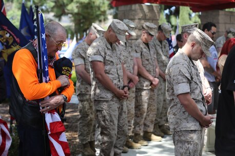 MARINE CORPS BASE CAMP PENDLETON, Calif. – Jim Reed bows his head in prayer during the 3rd Battalion, 5th Marine Regiment “Dark Horse” Reunion at the San Mateo Memorial Garden April 29, 2016. Reed, a retired Navy master chief and Vietnam War veteran, served 23 years and is now a Patriot Guard Rider. (U.S. Marine Corps photo by Lance Cpl. Shellie Hall/Released)