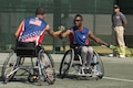 Retired Sgt. R.J. Anderson, right, and retired Navy Javier Rodriguez shake hands after scoring a point while competing against the Australians in the tennis quarterfinals during the 2016 Invictus Games in Orlando, Fla., May 6, 2016. DoD photo by Roger Wollenberg