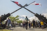 Mount Fuji watches over the Fuji Friendship Festival at Combined Arms Training Center Fuji, Gotemba, Japan, May, 2016. The festival included fun and games for all ages, such as bounce houses, face painting and live music from local artists and the U.S. 7th Fleet Band’s Orient Express. The festival also had numerous displays of weapon systems along with aircraft and vehicles. Among them were Japanese tanks, a UH60 Black Hawk and the MV-22B Osprey.