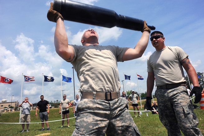 Army Pfc. Harlan Troutman, left, hoists a training round above his head during the Gen. Gordon Sullivan Cup best tank crew competition at Fort Benning, Ga., May 1, 2016. Troutman is assigned to the Tennessee Army National Guard’s 2nd Squadron, 278th Armored Cavalry Regiment. Army photo by Sgt. 1st Class Jon Soucy