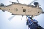 Navy Seaman Apprentice Deandre Robertson and Seaman Alonzo Brantley hook a pendant cargo line to an MH-60S Seahawk helicopter during a vertical replenishment on the USS Mobile Bay in the South China Sea, May 6, 2016. The Bay is operating on a regularly scheduled 7th Fleet deployment. Navy photo by Petty Officer 2nd Class Ryan J. Batchelder