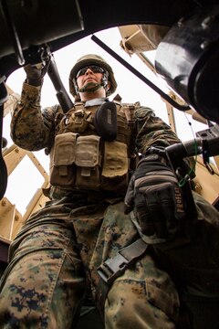 Cpl. Michael Martinez, a bulk fuels specialist with Marine Wing Support Squadron 171 mans a M240 bravo light-machine while convoying to a simulated aircraft crash site during exercise Thunder Horse 16.2 at the Japan Ground Self-Defense Force’s Haramura Maneuver Area in Hiroshima, Japan, May 11, 2016. The squadron conducts exercises such as this several times a year in order to train all the Marines within the squadron, enhance their technical skills, field experience and military occupational specialty capabilities. (U.S. Marine Corps photo by Lance Cpl. Aaron Henson/Released)