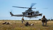 Marines from across I Marine Expeditionary Force post security during fast rope inserts on Marine Corps Base Camp Pendleton, Calif. May 9, 2016. This training was a part of a helicopter rope suspension techniques training package facilitated by 1st Air Naval Gunfire Liaison Company, I MEF. Marines and Royal British Commandos practiced these techniques on a rappel tower prior to fast roping out of helicopters hovering nearly 40 feet off  the ground. 