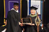 Lt. Gen. Stewart addressed the graduating class of Western Illinois University, his alma mater, on May 14 and received the Distinguished Alumni Award. Carol Scott, President of the WIU Alumni Council, presents Lt. Gen. Stewart with the award.
