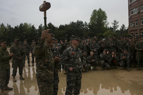 U.S. Marines and Sailors with Alpha Company, 1st Battalion, 3rd Marine Regiment, also known as “The Lava Dogs”, present a gift to Republic of Korea (ROK) marines during the Korean Marine Exchange Program (KMEP) in South Korea, April 13, 2016. KMEP is a program designed to increase interoperability and camaraderie between U.S. Marines and ROK marines. The alliance between America and the Republic of Korea has grown ever stronger based upon the shared interests and common values of both nations. (U.S. Marine Corps photo by MCIPAC Combat Camera Lance Cpl. Sean M. Evans/ Released)
