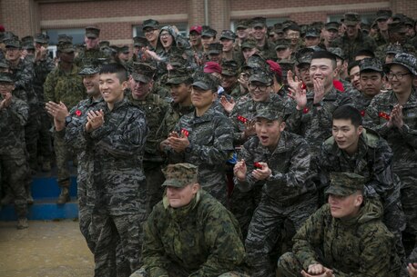 U.S. Marines and Sailors with Alpha Company, 1st Battalion, 3rd Marine Regiment, also known as “The Lava Dogs”, present a gift to Republic of Korea (ROK) marines during the Korean Marine Exchange Program (KMEP) in South Korea, April 13, 2016. KMEP is a program designed to increase interoperability and camaraderie between U.S. Marines and ROK marines. The alliance between America and the Republic of Korea has grown ever stronger based upon the shared interests and common values of both nations. (U.S. Marine Corps photo by MCIPAC Combat Camera Lance Cpl. Sean M. Evans/ Released)