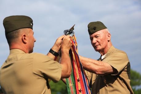 Lt. Gen. John A. Toolan, commander, U.S. Marine Corps Forces, Pacific and Col. Peter S. Gadd, Headquarters and Service Battalion commanding officer, MARFORPAC, attach a Meritorious Unit Commendation streamer to the colors during a battalion formation on Camp H.M. Smith, Hawaii, May 6, 2016. The formation was held to award the Marines of MARFORPAC a Meritorious Unit Commendation, the shooting team the Master Gunnery Sgt. Michael T. Finn trophy for winning the Pacific Division pistol matches, and the MARFORPAC Band the U.S. Marine Corps Band of the Band of the Year trophy.