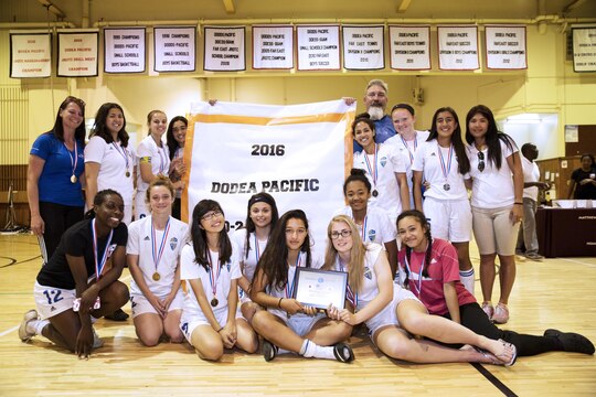 Players and coaches from the Panthers girls’ soccer team from Yokota High School, Yokota Air Base, pose with their plaque and banner after winning first place in the Far East Soccer Tournament hosted by Matthew C. Perry High School at Marine Corps Air Station Iwakuni, Japan, May 19, 2016. The Far East Soccer Tournament is the largest soccer event that Department of Defense Education Activity Schools Pacific in mainland Japan, Okinawa, Korea and International Schools have to look forward to compete in all season. (U.S. Marine Corps photo by Lance Cpl. Donato Maffin/Released)