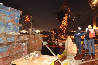 The U.S. Army Corps of Engineers, New York District, and U.S. Navy Supervisor of Salvage, personnel observe over night crane operations to remove derelict barges from Flushing Bay, in Queens, N.Y.  