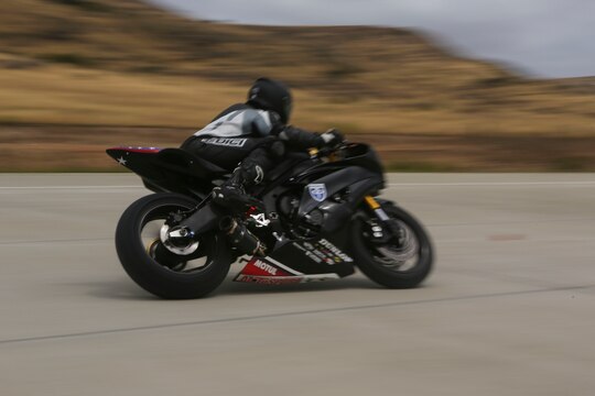 A service member with 3rd Marine Aircraft Wing rides on the helicopter landing field turned motorcycle track during Motorcycle Rider Preservation Day 2016 in San Mateo Canyon on Marine Corps Base Camp Pendleton, Calif., May 20. Marine Aircraft Group 39 partnered with Marine Corps Base Camp Pendleton Motorcycle Safety Division to host Motorcycle Rider Preservation Day 2016 for 3rd MAW service members who own bikes. (U.S. Marine Corps photo by Lance Cpl. Harley Robinson/Released)