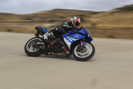 A service member with 3rd Marine Aircraft Wing rides on the helicopter landing field turned motorcycle track during Motorcycle Rider Preservation Day 2016 in San Mateo Canyon on Marine Corps Base Camp Pendleton, Calif., May 20. Marine Aircraft Group 39 partnered with Marine Corps Base Camp Pendleton Motorcycle Safety Division to host Motorcycle Rider Preservation Day 2016 for 3rd MAW service members who own bikes. (U.S. Marine Corps photo by Lance Cpl. Harley Robinson/Released)