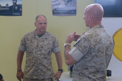 U.S. Marine Corps Brig. Gen. David Ottignon, commanding general, 1st Marine Logistics Group talks with Gen. Robert Neller, Commandant of the Marine Corps, about the current and future 3D printing operations using the Expeditionary Manufacturing System within the 1st MLG on Camp Pendleton, Calif., May 24, 2016. The Expeditionary Manufacturing System is a mobile 3D printing and milling shop designed to provide quick turnaround for mission critical parts in deployed environment. (U.S. Marine Corps photo by Sgt. Rodion Zabolotniy, Combat Camera, Camp Pendleton/RELEASED)
