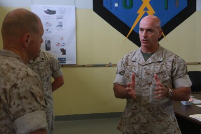 U.S. Marine Corps Brig. Gen. David Ottignon, commanding general, 1st Marine Logistics Group  talks with Gen. Robert Neller, Commandant of the Marine Corps, about the current and future 3D printing operations using the Expeditionary Manufacturing System within the 1st MLG on Camp Pendleton, Calif., May 24, 2016. The Expeditionary Manufacturing System is a mobile 3D printing and milling shop designed to provide quick turnaround for mission critical parts in deployed environment. (U.S. Marine Corps photo by Sgt. Rodion Zabolotniy, Combat Camera, Camp Pendleton/RELEASED)