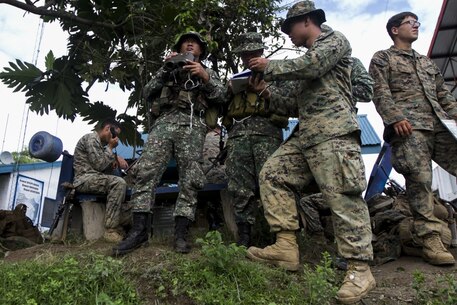 U.S. Marines with the 31st Marine Expeditionary Unit and members of the Philippine Marine Corps designate target points for artillery fire before the start of a combined-arms live-fire exercise (CALFEX) during Amphibious Landing Exercise 33 (PHIBLEX 33) at an observation post in Col. Ernesto Ravina Air Base, Philippines, Oct. 10, 2016. Marines with the 31st MEU joined members of the Philippine Marine Corps to take part in CALFEX, the culminating event of PHIBLEX 33. PHIBLEX 33 is an annual bilateral exercise conducted with the Armed Forces of the Philippines that combines amphibious capabilities and live-fire training with humanitarian civic assistance efforts to strengthen interoperability and working relationships through commitment, capability and cooperation.