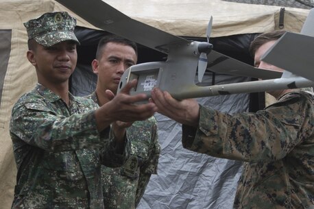 Philippine Marines learn about the RQ-11 Raven unmanned aerial system from a U.S. Marine with the 31st Marine Expeditionary Unit during training at Colonel Ernesto Ravina Air Base, Philippines, during Philippine Amphibious Landing Exercise 33 (PHIBLEX), Oct. 8, 2016. The Philippine Marines partner with their U.S. counterparts routinely to share tactics, techniques and procedures to further the U.S-Philippine bilateral partnership. PHIBLEX is an annual U.S.-Philippine military bilateral exercise combining amphibious capabilities and live-fire training with humanitarian civic assistance efforts to strengthen interoperability and working relationships. (U.S. Marine Corps Photo by Staff Sgt. T.T. Parish/Released)