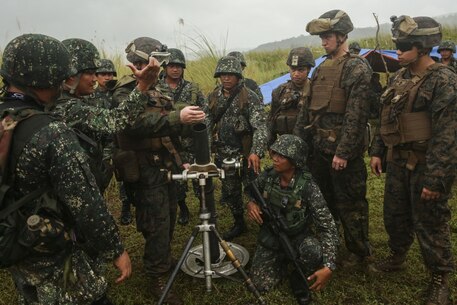 Philippine and U.S. Marines with the 31st Marine Expeditionary Unit share mortar-firing techniques during Philippine Amphibious Landing Exercise 33 (PHIBLEX) in Colonel Ernesto Ravena Air Base, Philippines, Oct. 8, 2016. The U.S. and Philippine Marine mortarmen worked together to share information about how their different mortar systems operate. PHIBLEX is an annual U.S.-Philippine military bilateral exercise combining amphibious capabilities and live-fire training with humanitarian civic assistance efforts to strengthen interoperability and working relationships. (U.S. Marine Corps photo by Lance Cpl. Jay A. Parks/Released) 