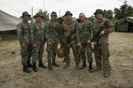 Philippine Marines and U.S. Marines pose for a photo during Philippine Amphibious Landing Exercise 33 (PHIBLEX) on Colonel Ernesto Ravina Air Base, Philippines, Oct. 7, 2016. PHIBLEX is an annual U.S.-Philippine military bilateral exercise that combines amphibious capabilities and live-fire training with humanitarian civic assistance efforts to strengthen interoperability and working relationships. The Philippine Marines are with Battalion Landing Team, 2nd Battalion, 32nd Marine Company. The U.S. Marines are with Battalion Landing Team, 2nd Battalion, 4th Marine Regiment, Echo Company. (U.S. Marine Corps photo by MCIPAC Combat Camera Lance Cpl. Jesula Jeanlouis/Released)