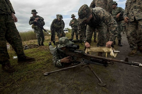 Marines with Company G, Battalion Landing Team, 2nd Battalion, 4th Marine Regiment, 31st Marine Expeditionary Unit, discuss the M240B machine gun with Philippine Marines during Philippine Amphibious Landing Exercise 33 (PHIBLEX) at the Naval Education and Training Command, Philippines, Oct. 5, 2016. PHIBLEX is an annual bilateral exercise conducted with the Armed Forces of the Philippines that combines amphibious capabilities and live-fire training with humanitarian civic assistance efforts to strengthen interoperability and working relationships through commitment, capability and cooperation.(U.S. Marine Corps photo by Cpl. Jorge A. Rosales) 