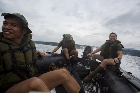 U.S. Marine Corps Cpl. Eduardo Diaz-Salazar, right, a coxswain assigned to Fox Company, Battalion Landing Team, 2nd Battalion, 4th Marine Regiment, 31st Marine Expeditionary Unit, rides aboard a combat rubber raiding craft with Philippine Marines as part of Philippine Amphibious Landing Exercise 33 (PHIBLEX) off the coast of Marine Barracks Gregorio Lim, Ternate, Philippines, Oct. 5, 2016. PHIBLEX 33 is an annual bilateral exercise conducted with the Armed Forces of the Philippines that combines amphibious capabilities and live-fire training with humanitarian civic assistance efforts to strengthen interoperability and working relationships through commitment, capability and cooperation. (U.S. Marine Corps photo by Cpl. Darien J. Bjorndal, 31st Marine Expeditionary Unit/ Released) 