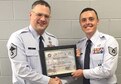 Senior Master Sgt. John Roy, 332nd Recruiting Squadron production superintendent, presents Tech. Sgt. Miles Gravage, 332nd RCS, A-Flight, his recruiter certification in Murfreesboro, Tenn., Nov. 3.